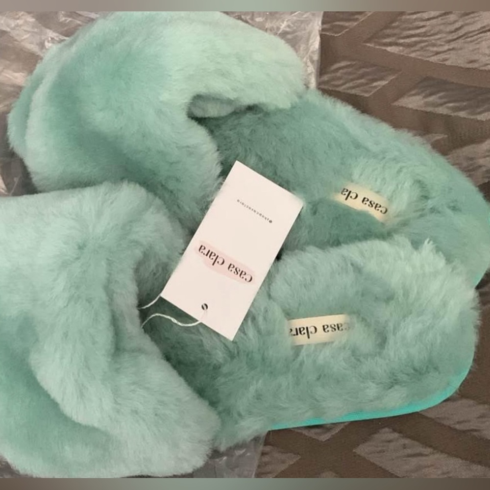 Casa Clara mint colored, soft, fuzzy slippers.